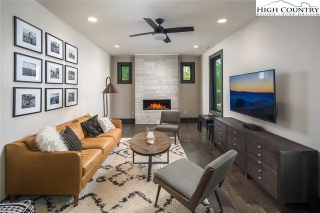 a living room with furniture and wooden floor