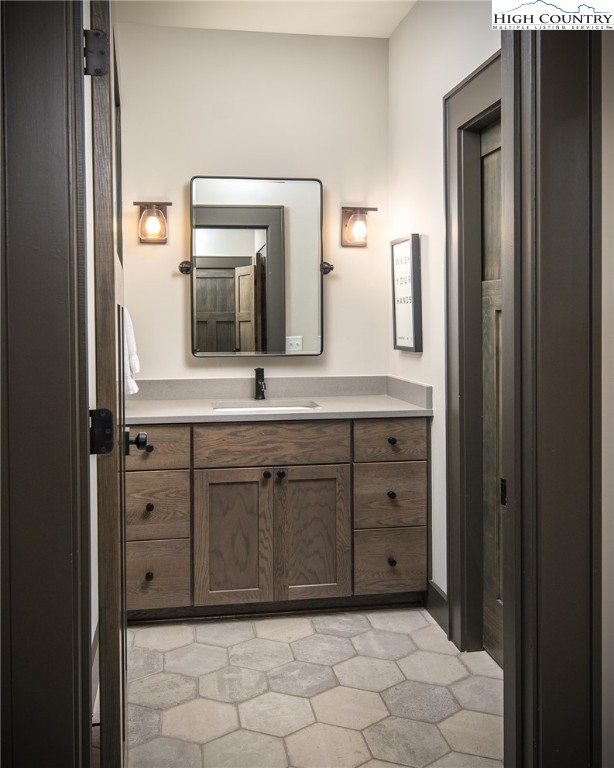 137 Sweetspire Lane Boone, NC 28607 - Photo 22 of 50 a bathroom with a sink and a mirror
