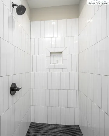 a bedroom with a bed and large windows