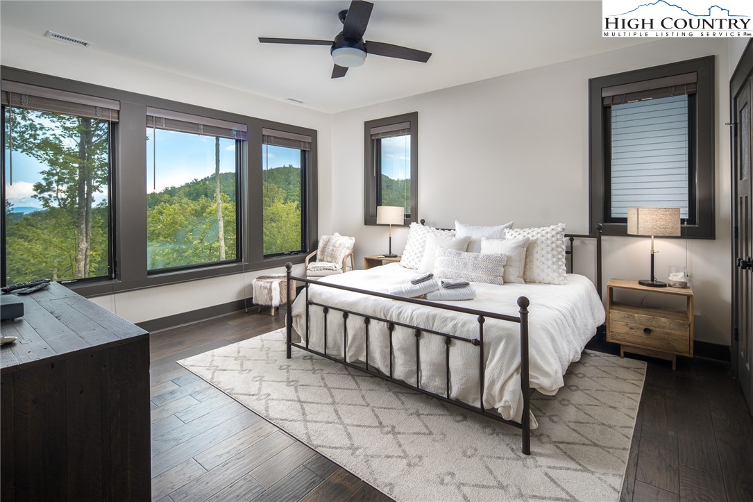 137 Sweetspire Lane Boone, NC 28607 - Photo 24 of 50 a bedroom with a bed and large windows