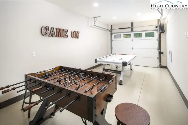 a room with furniture and air hockey table