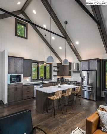 a kitchen with a table chairs microwave and cabinets