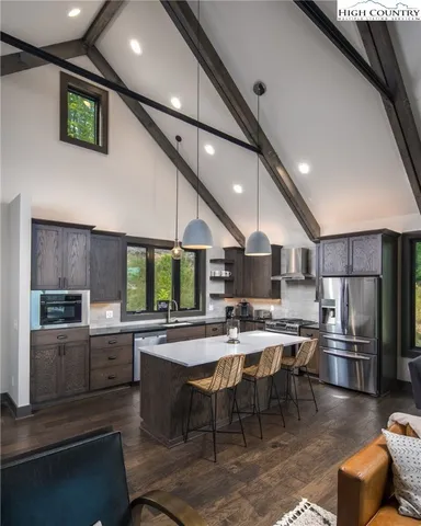 a kitchen with a table chairs microwave and cabinets
