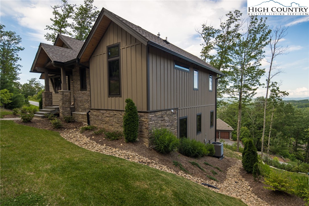 137 Sweetspire Lane Boone, NC 28607 - Photo 31 of 50 a front view of a house with garden