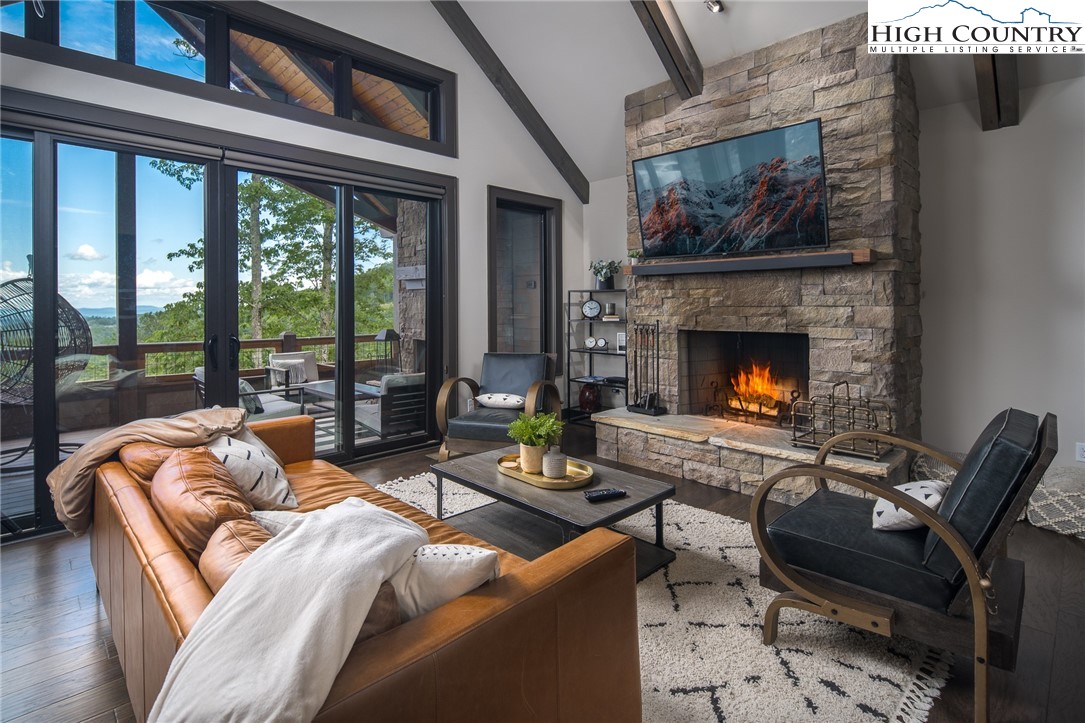 137 Sweetspire Lane Boone, NC 28607 - Photo 7 of 50 a living room with furniture fireplace and a large window