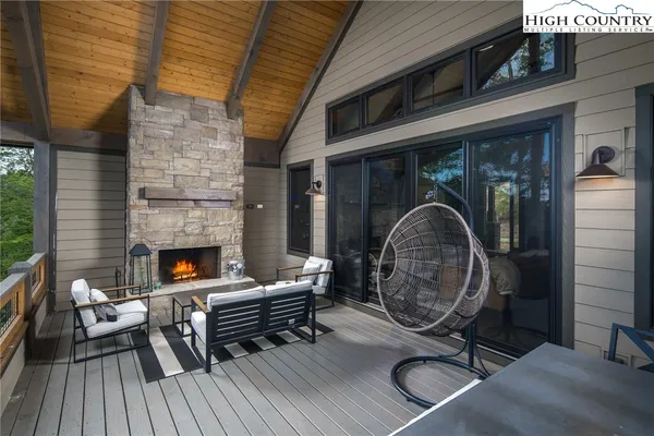 a balcony with wooden floor and outdoor seating