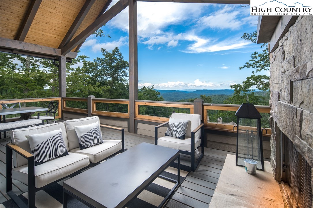 137 Sweetspire Lane Boone, NC 28607 - Photo 9 of 50 a balcony with wooden floor and outdoor seating