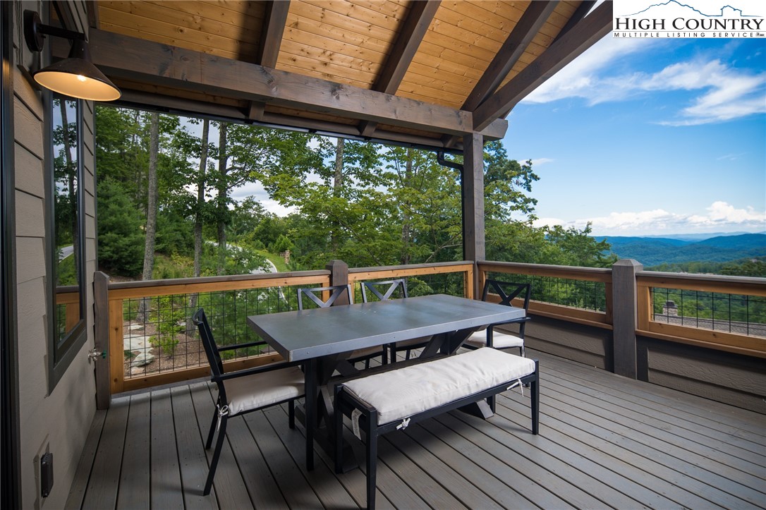 137 Sweetspire Lane Boone, NC 28607 - Photo 10 of 50 a view of a balcony with chairs and wooden floor