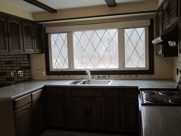 124 East County Road Rutland, MA 01543 - Photo 15 of 22 a kitchen with a sink a window and cabinets