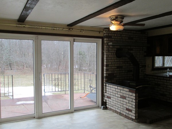 124 East County Road Rutland, MA 01543 - Photo 16 of 22 a room with sliding door and a ceiling fan