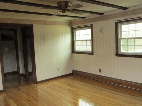 124 East County Road Rutland, MA 01543 - Photo 18 of 22 an empty room with wooden floor and windows