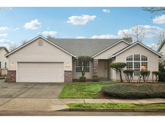 a front view of a house with a yard and garage