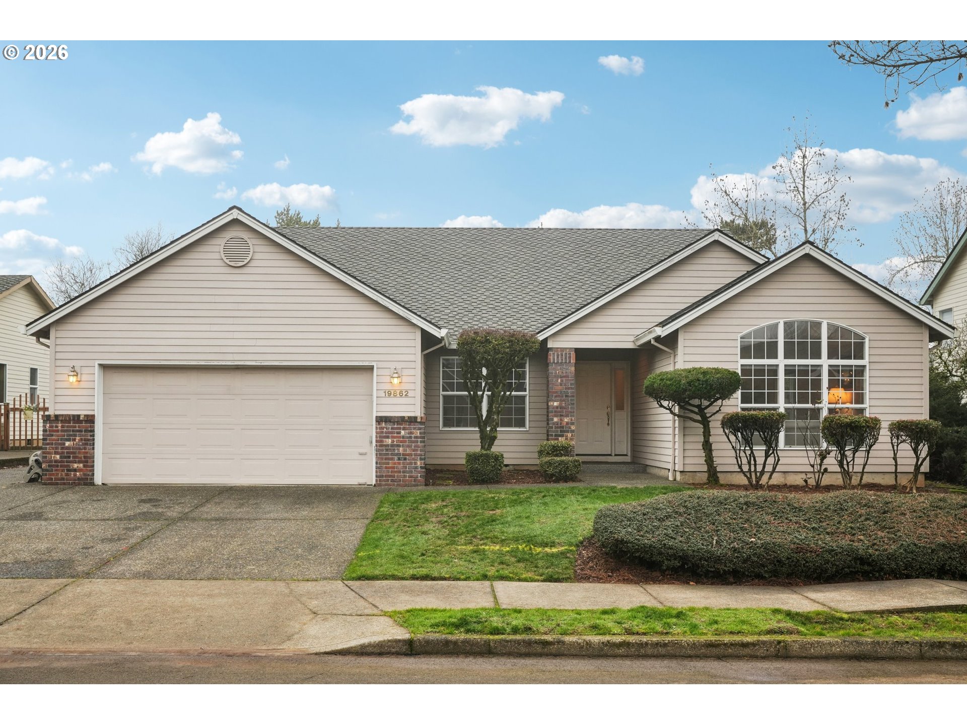 a front view of a house with a yard and garage
