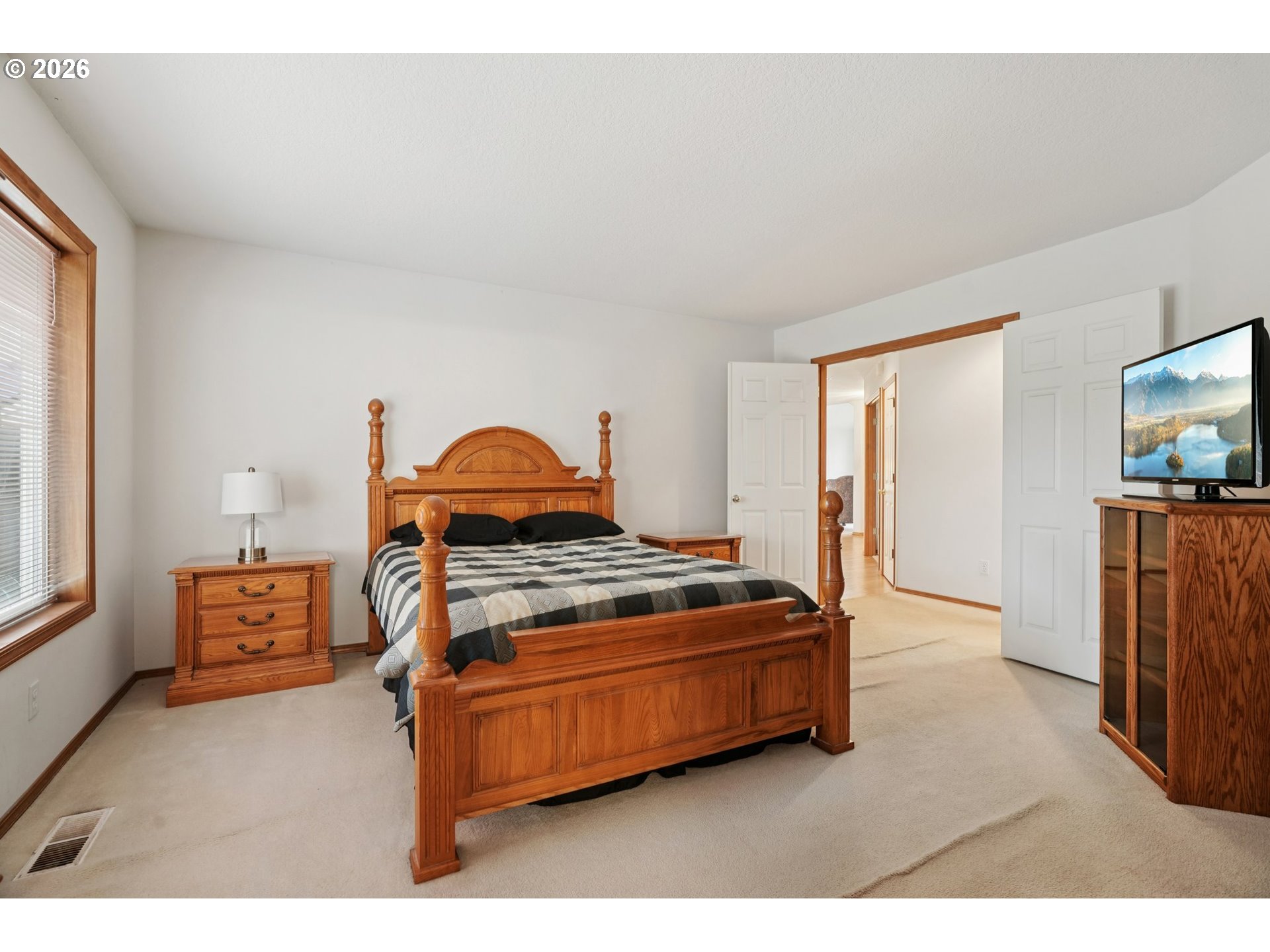 19862 Castleberry Loop Oregon City, OR 97045 - Photo 17 of 33 a bedroom with a bed and a flat screen tv