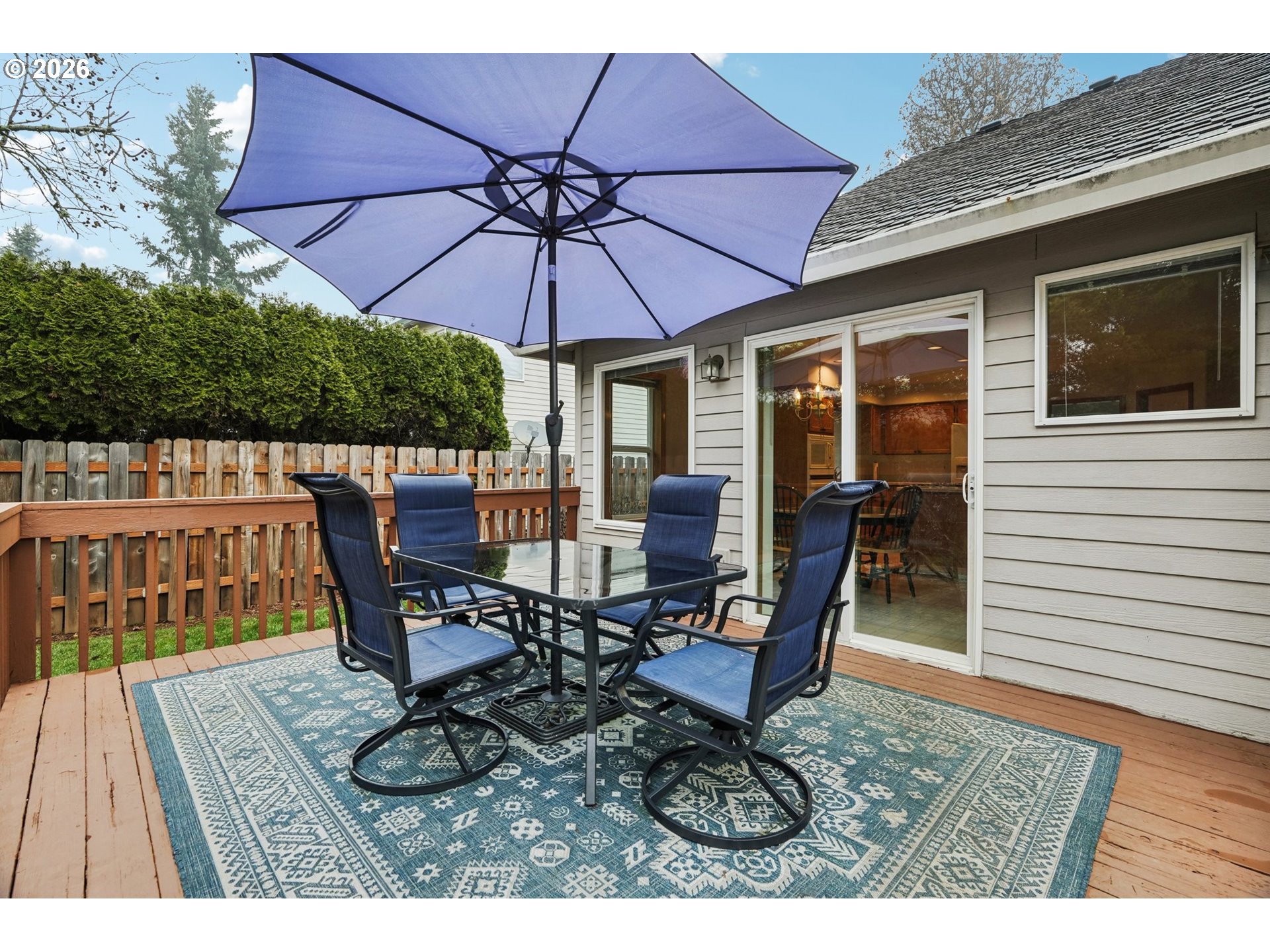 19862 Castleberry Loop Oregon City, OR 97045 - Photo 25 of 33 a view of a roof deck with table and chairs under an umbrella