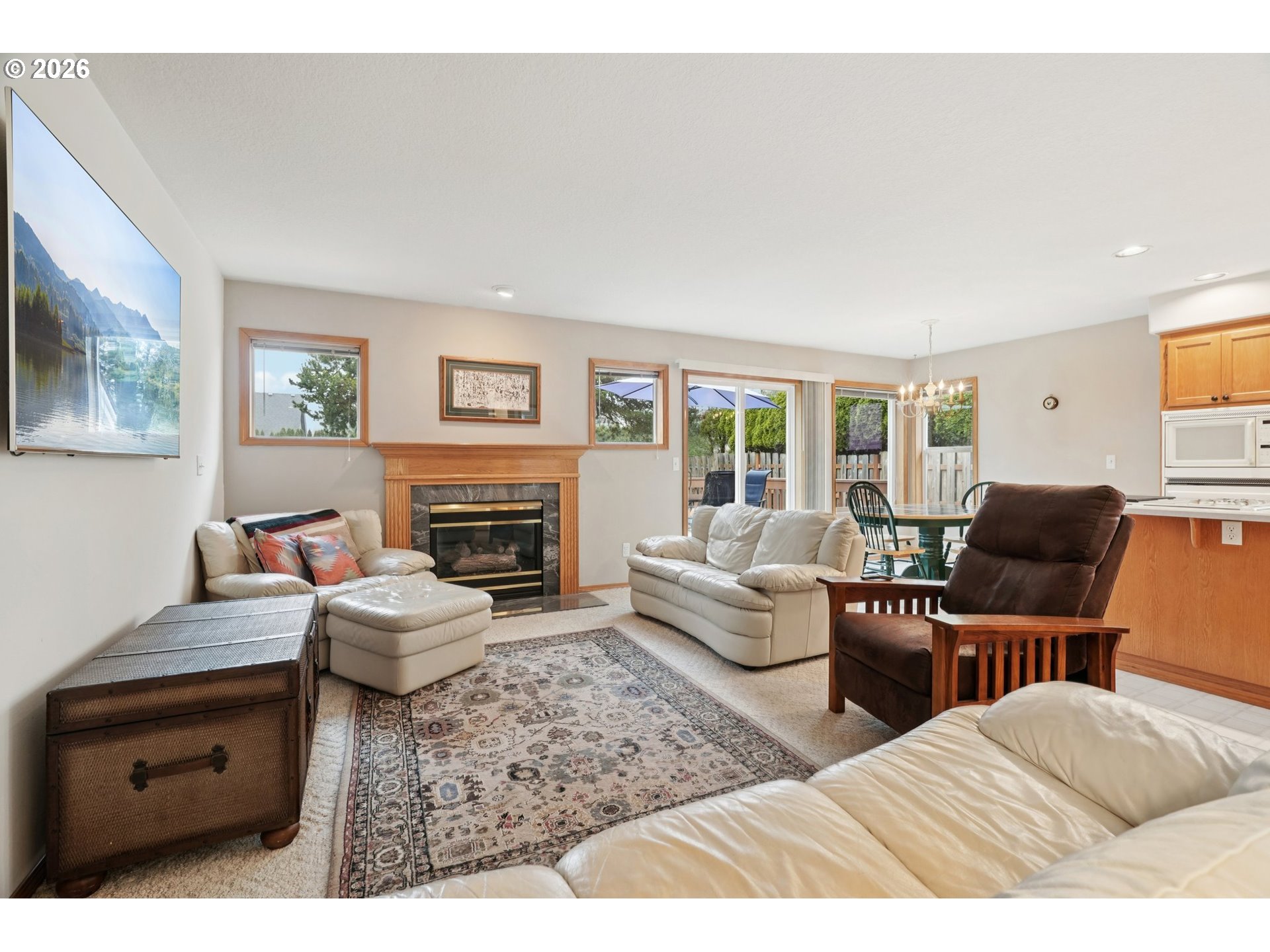 19862 Castleberry Loop Oregon City, OR 97045 - Photo 4 of 33 a living room with furniture a fireplace and a flat screen tv
