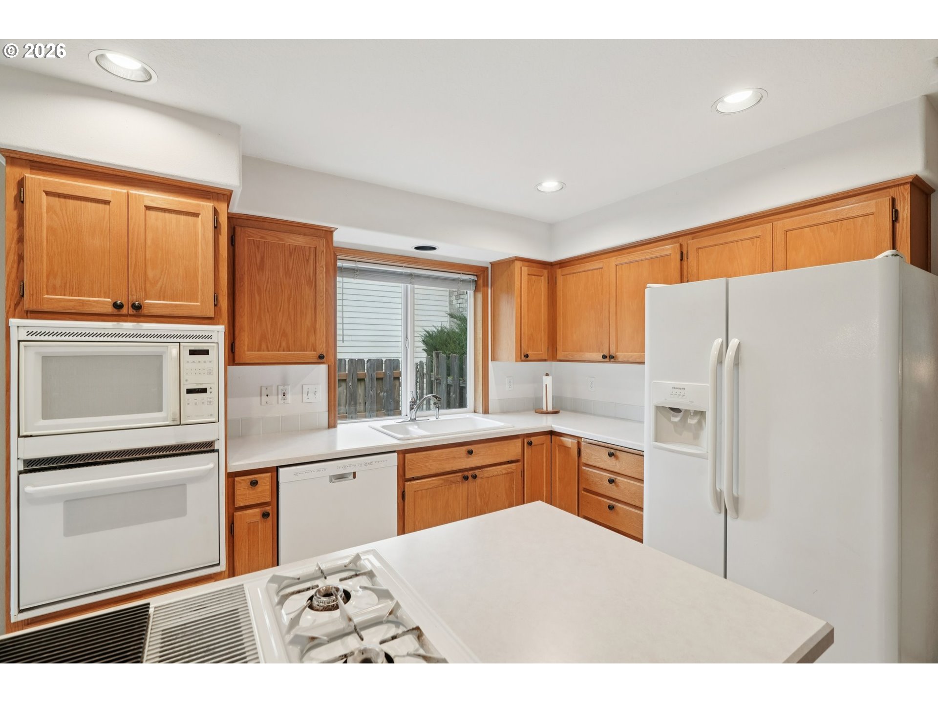 19862 Castleberry Loop Oregon City, OR 97045 - Photo 7 of 33 a kitchen with a refrigerator sink and cabinets