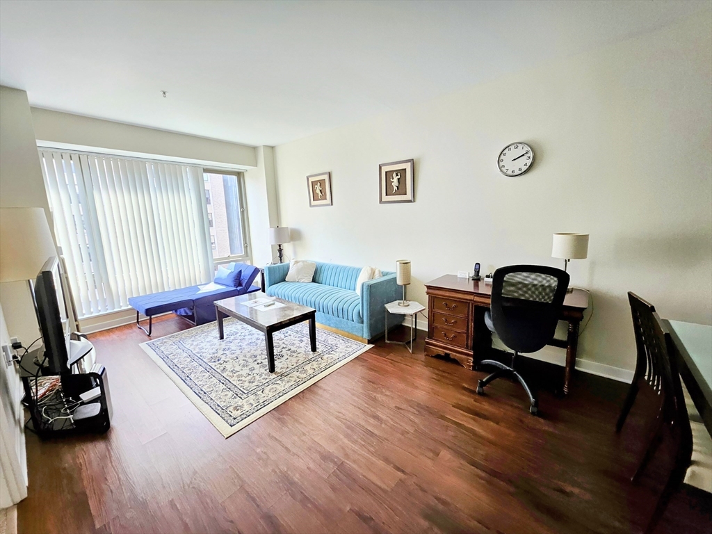 175 Blossom Street, Unit 2 Boston, MA 02114 - Photo 1 of 4 a living room with furniture rug and window