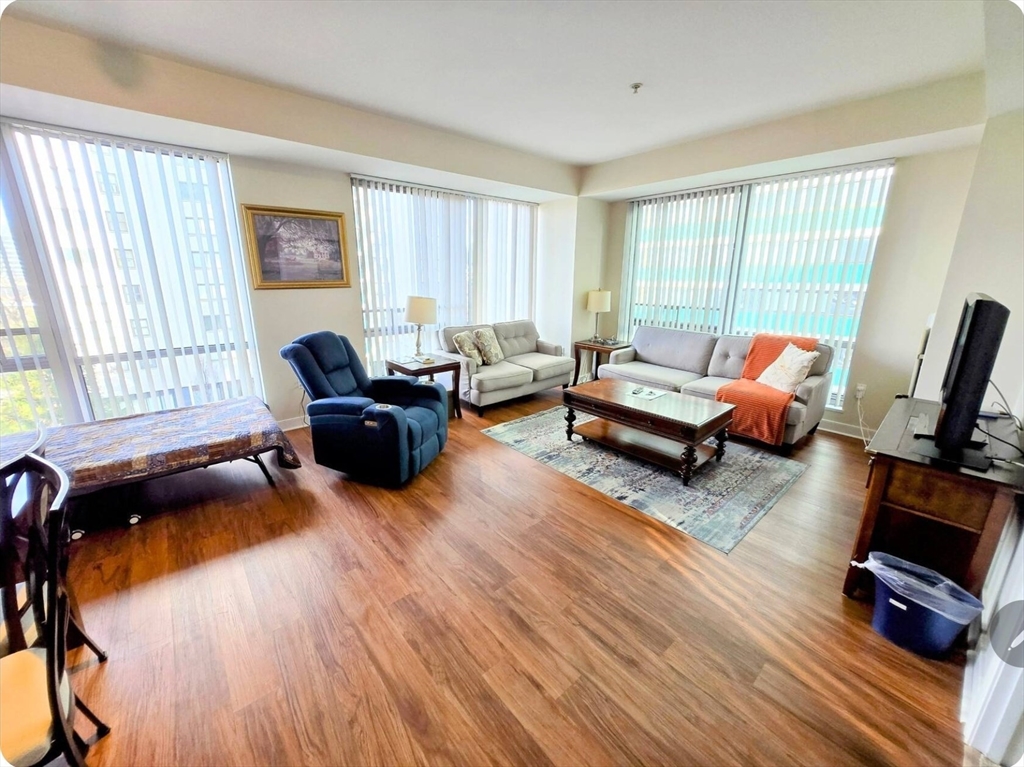 175 Blossom Street, Unit 2 Boston, MA 02114 - Photo 3 of 4 a living room with furniture and wooden floor