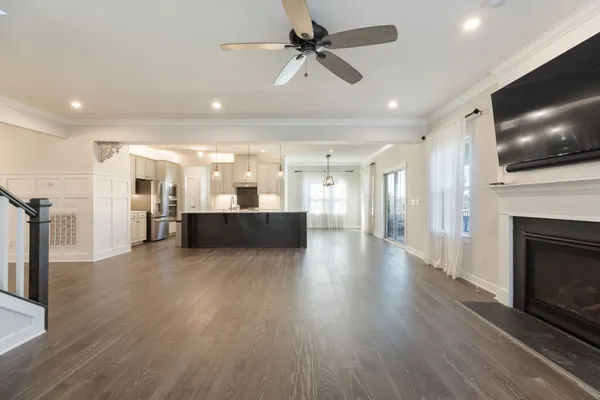 a kitchen with stainless steel appliances a sink a stove and a wooden floors