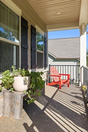 a view of a hallway with wooden floor and windows