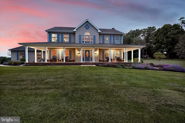 front view of a house with a yard table and chairs