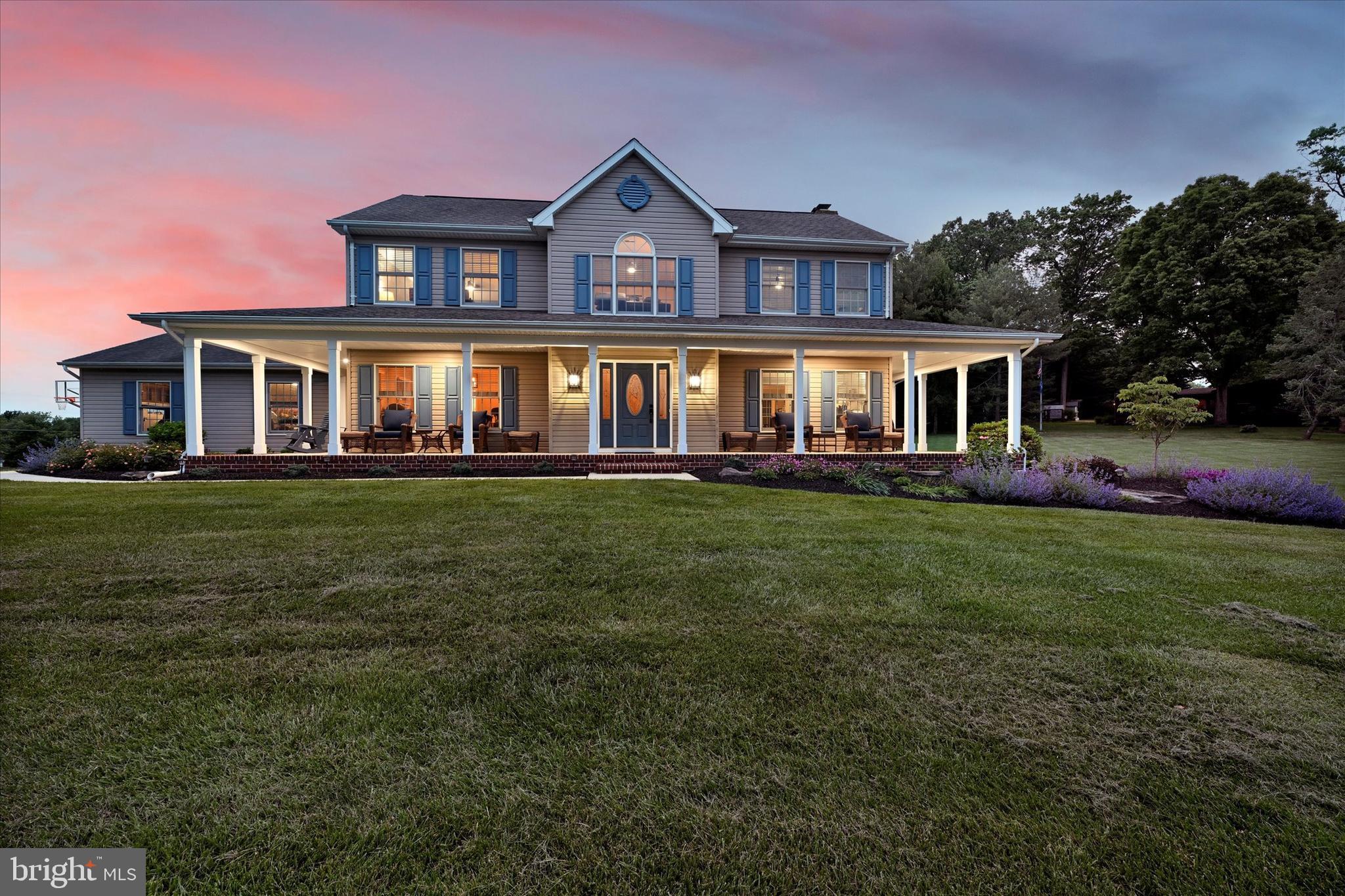 front view of a house with a yard table and chairs