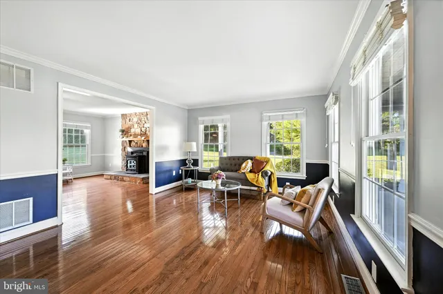 a kitchen with stainless steel appliances kitchen island granite countertop a refrigerator a sink a stove and white cabinets