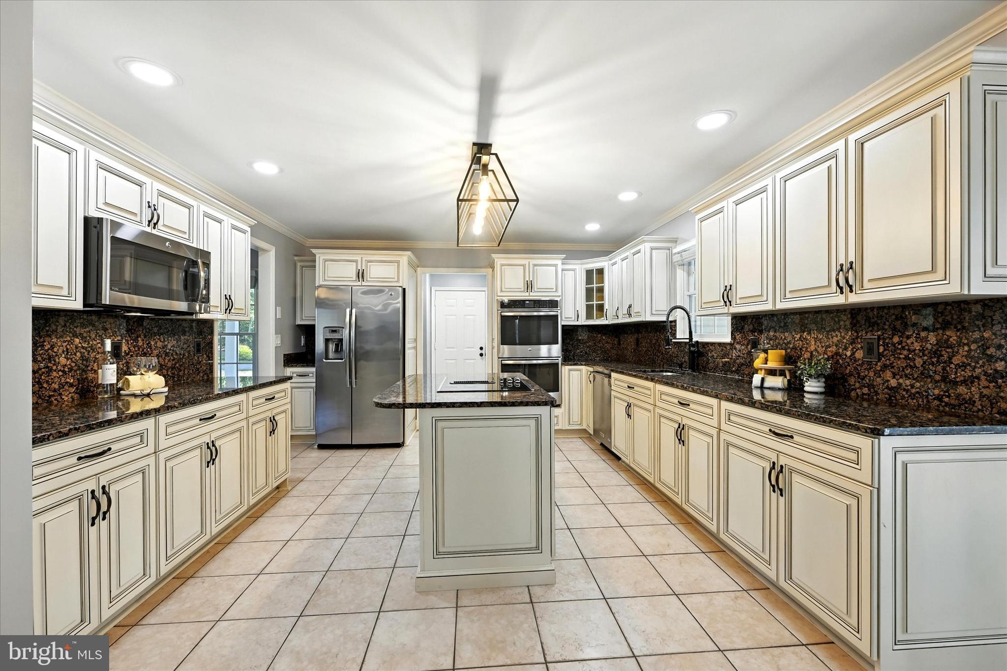 1014 Bernoudy Road White Hall, MD 21161 - Photo 20 of 73 a kitchen with stainless steel appliances kitchen island granite countertop a refrigerator and microwave