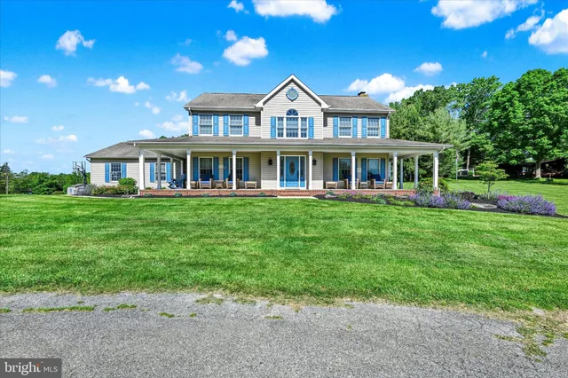 a front view of a house with a yard table and chairs