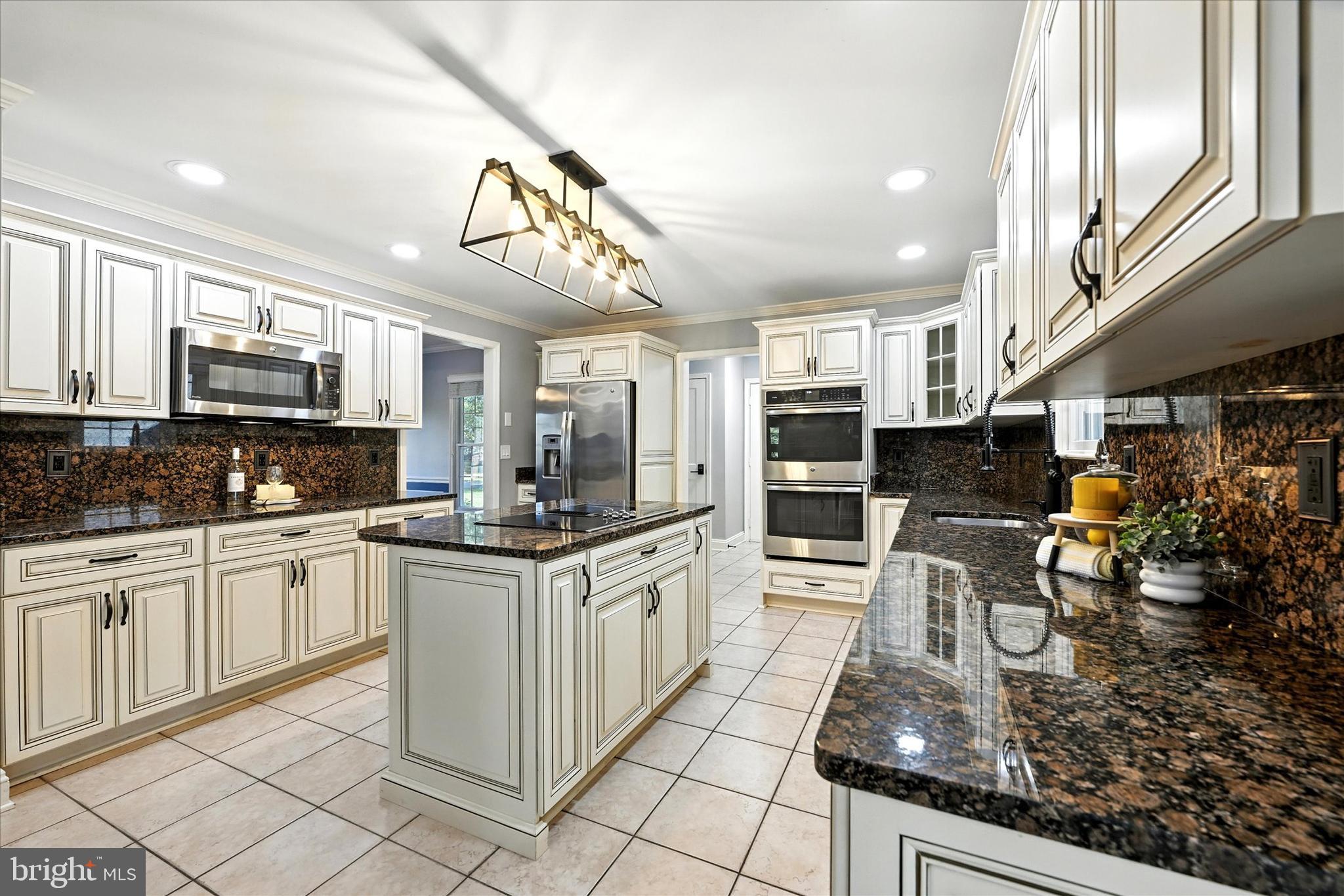 1014 Bernoudy Road White Hall, MD 21161 - Photo 22 of 73 a kitchen with stainless steel appliances kitchen island granite countertop a sink and cabinets