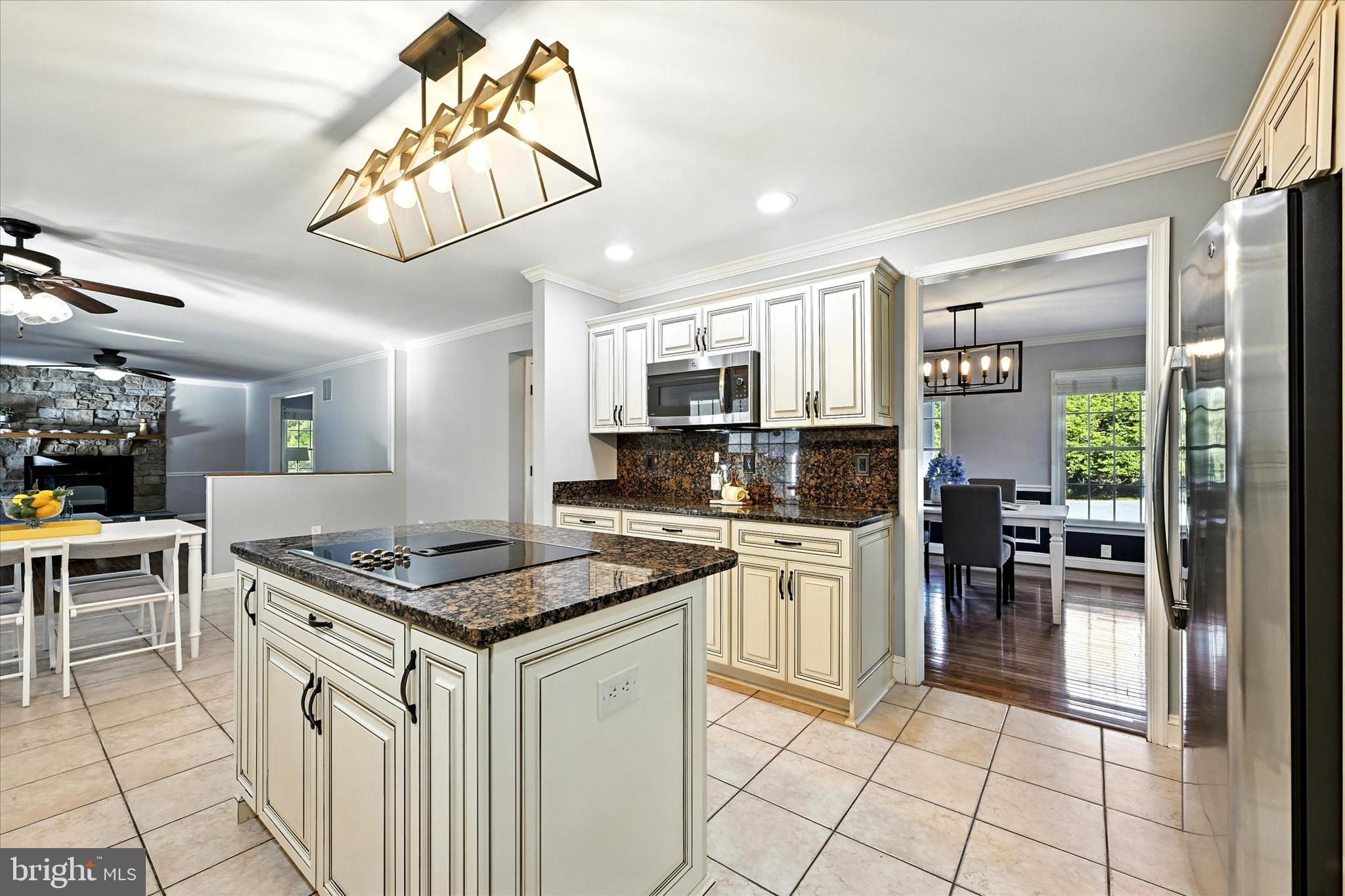 1014 Bernoudy Road White Hall, MD 21161 - Photo 23 of 73 a kitchen with stainless steel appliances granite countertop a stove a sink dishwasher a dining table and chairs with wooden floor