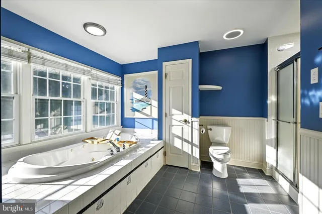 a view of a house with a big yard and large trees