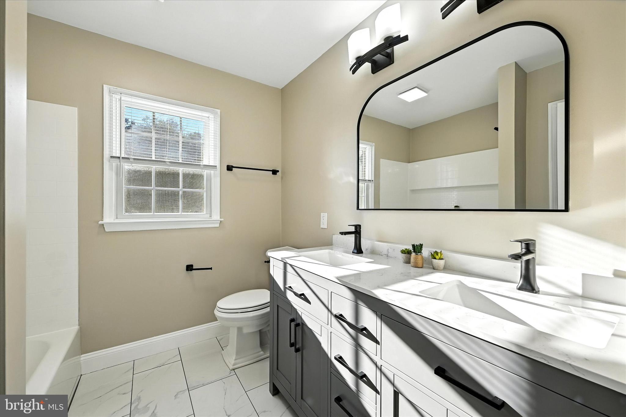 1014 Bernoudy Road White Hall, MD 21161 - Photo 42 of 73 a bathroom with a granite countertop sink a toilet and a mirror