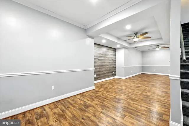 a view of a house with a big yard potted plants and a large tree