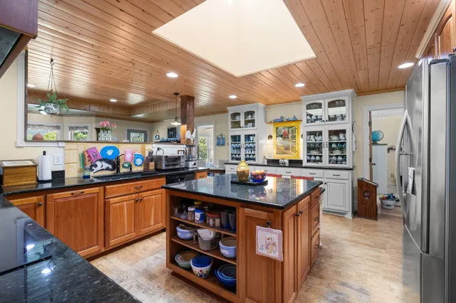 a kitchen with stainless steel appliances granite countertop a sink and a stove