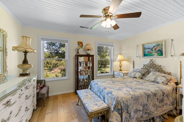 a bedroom with a bed and ceiling fan