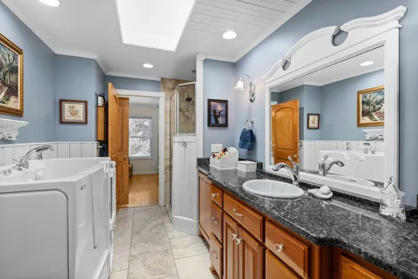 a bedroom with a bed and a mirror