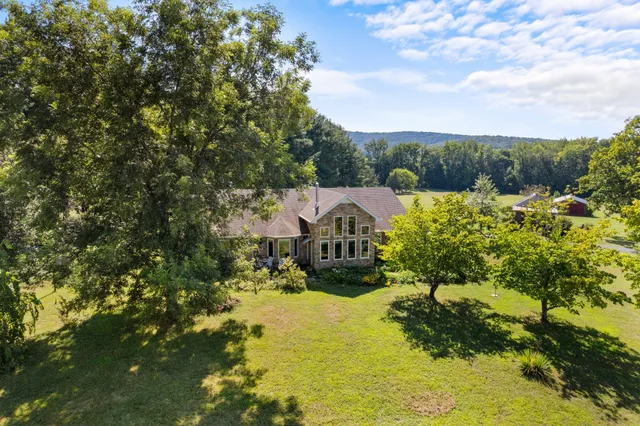 an aerial view of a house with a yard
