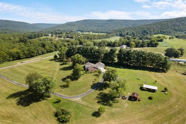 an aerial view of a house with a yard