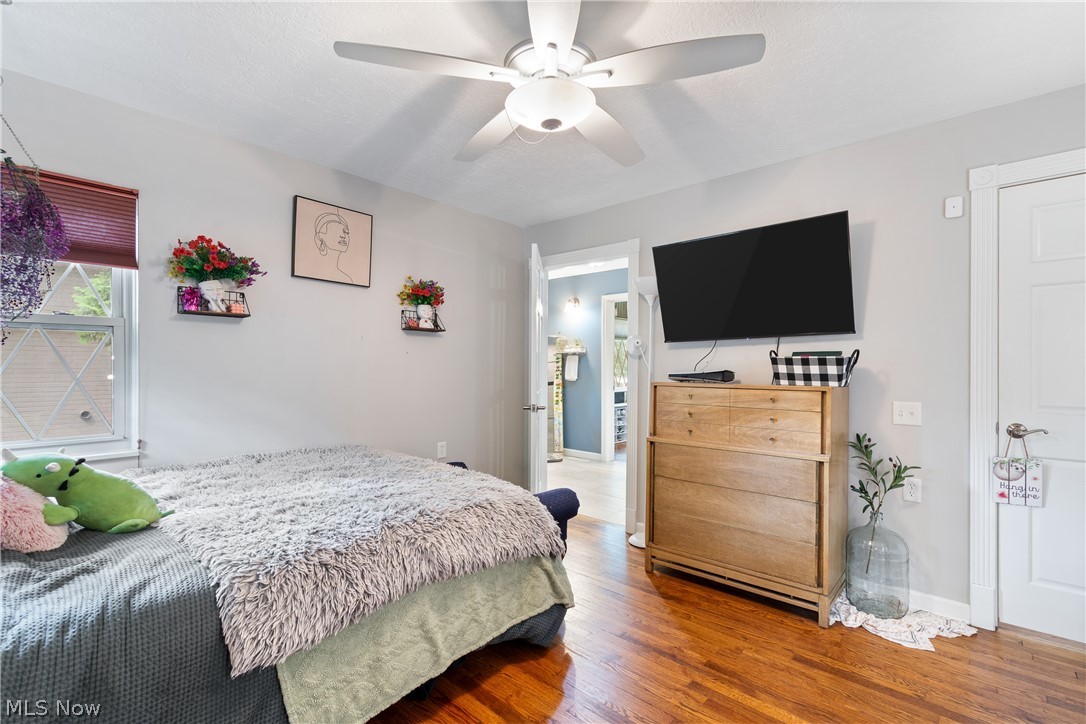 443 Merriman Road Akron, OH 44303 - Photo 27 of 44 Bedroom featuring wood-finish flooring, a ceiling fan with integrated lighting, and a white interior door