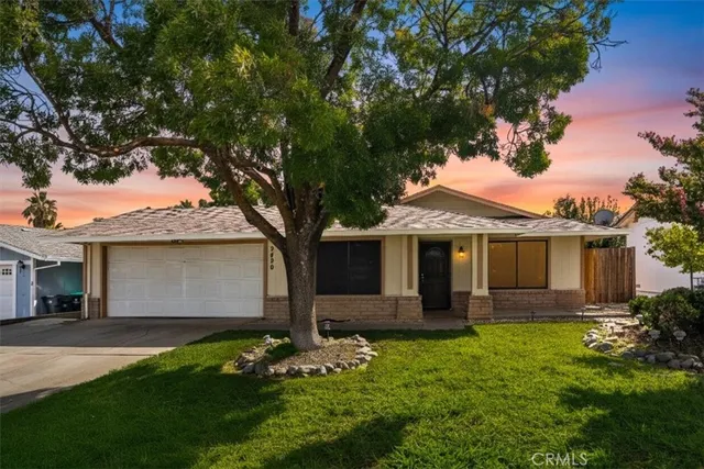 a front view of a house with a garden and yard