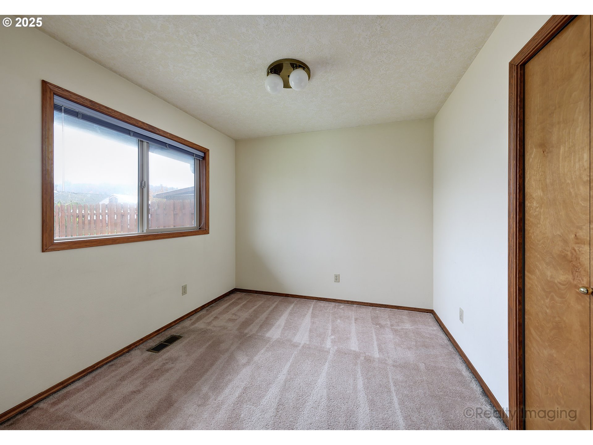 3756 Southwest 7th Court Gresham, OR 97030 - Photo 14 of 29 a view of an empty room with wooden floor and a window