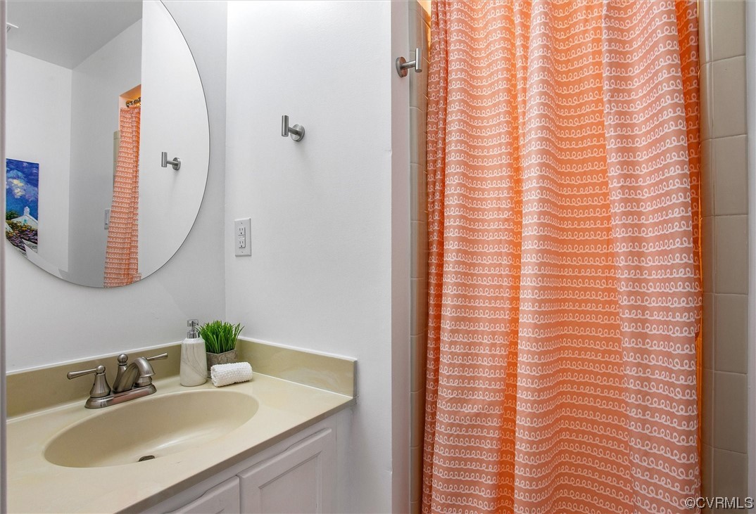 2734 Berkeley Pointe Drive Richmond, VA 23233 - Photo 26 of 31 a bathroom with a sink and a mirror