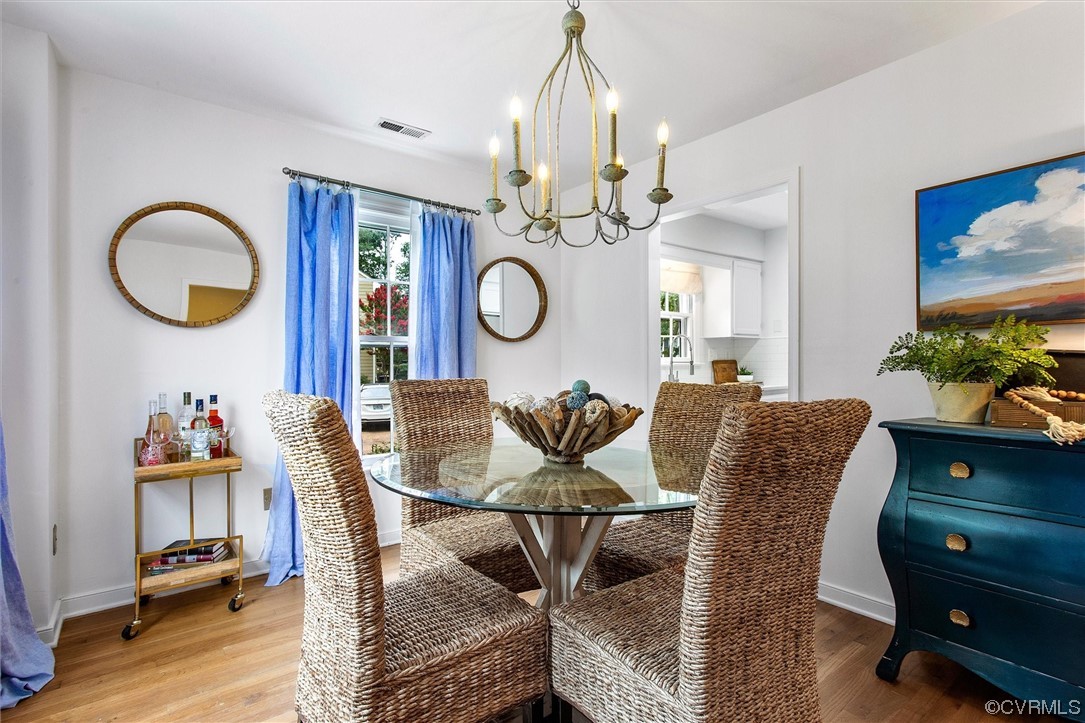 2734 Berkeley Pointe Drive Richmond, VA 23233 - Photo 6 of 31 a living room with furniture a dining table and paintings on the wall