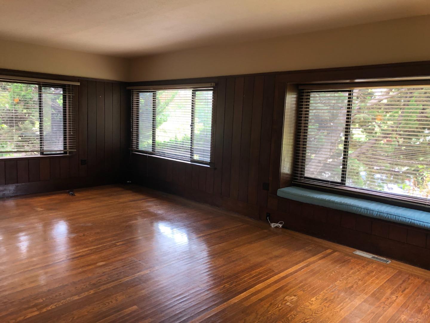2629 Piedmont Avenue, Unit E Berkeley, CA 94704 - Photo 4 of 14 a view of an empty room with wooden floor and a window