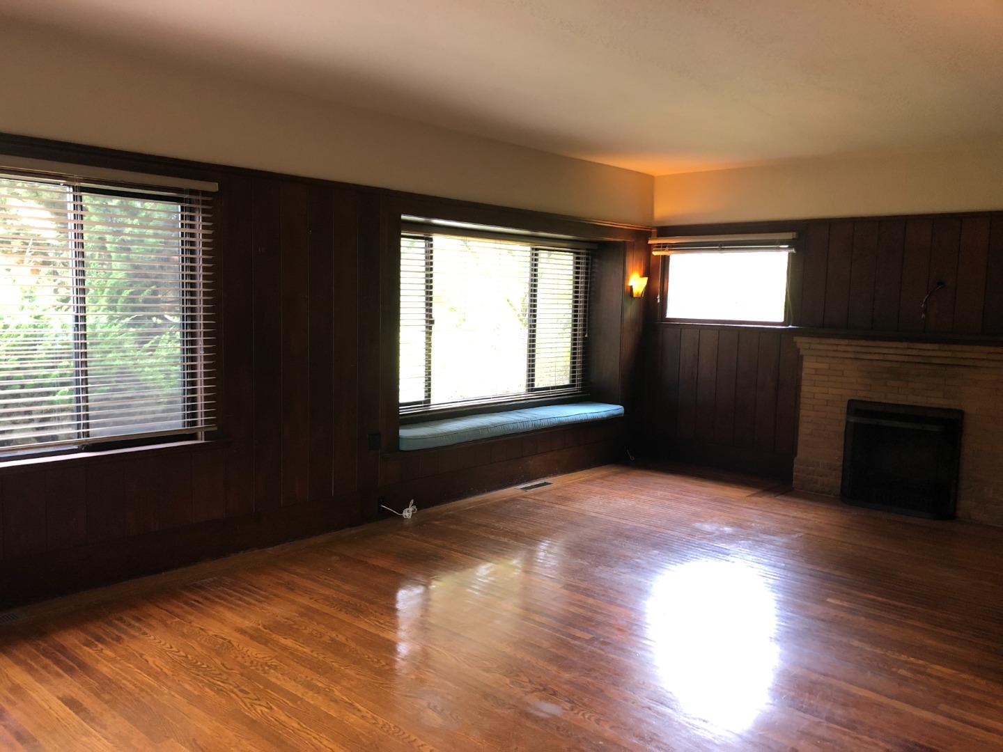 2629 Piedmont Avenue, Unit E Berkeley, CA 94704 - Photo 7 of 14 a view of empty room with wooden floor and fireplace