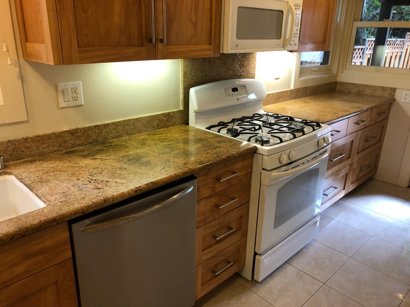 2629 Piedmont Avenue, Unit E Berkeley, CA 94704 - Photo 10 of 14 a kitchen with granite countertop a stove and a sink