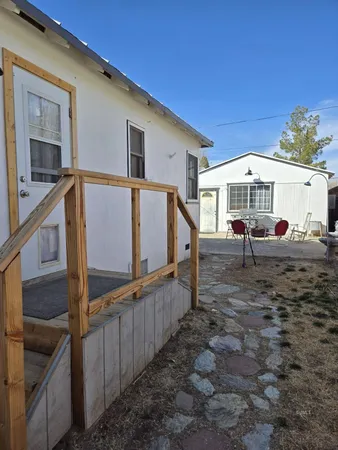 a view of a house with wooden fence