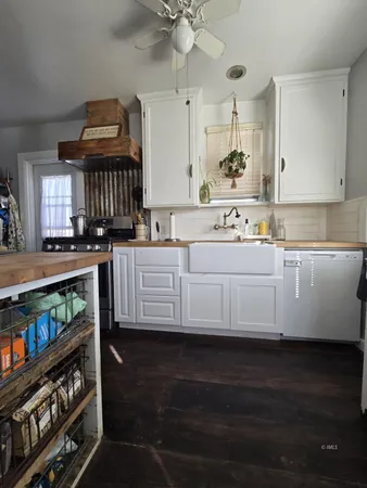 a kitchen with stainless steel appliances a sink dishwasher stove and cabinets